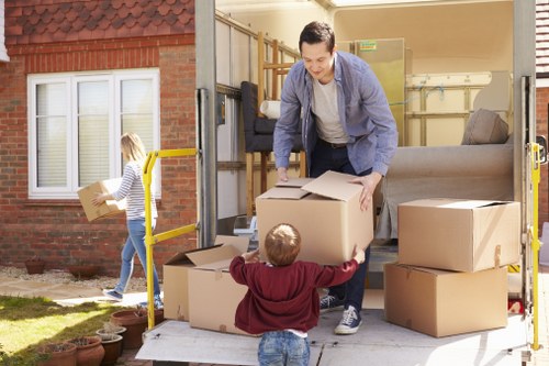 Professional packers working in a Maida Vale home with labelled boxes