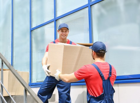 Loading furniture into a van during a removal service