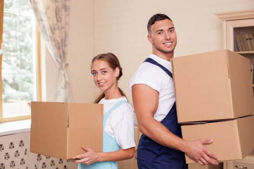 Movers handling household items carefully during a same day removals service in Maidavale