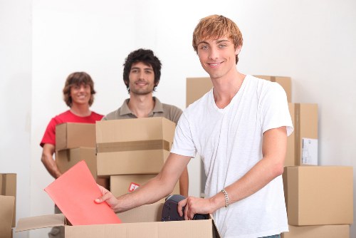 Packed moving boxes and furniture ready for transport in Maida Vale