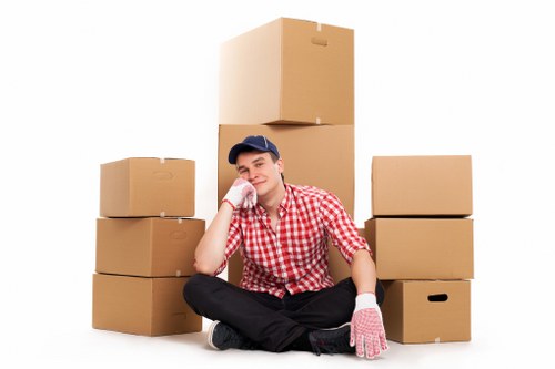 Moving day scene with Maidavale removalists organizing boxes and home furniture